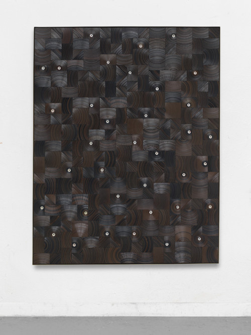 
     <i>Regen prasselt auf Boden (Holz)</i>, 
     2017<br />
     cassette tape, cassette wheel and canvas on wood in brass frame, 
      178 x 138 x 5 cm<br />
     