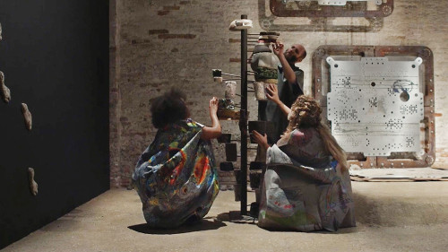 
     <i>Knot in Arrow: Ore Oral Orientation</i>, 
     2017<br />
      
     <br />
     Performance by Mariechen Danz with Ronel Doual, Marko Lakobrija, Brandon Rosenbluth, “Viva Arte Viva” curated by Christine Macel, 57. Biennale di Venezia, Venice, Italy, 2017
Music by Gediminas Žygus & UNMAP, aluminium works in cooperation with Genghis Khan Fabrication Co.
video still