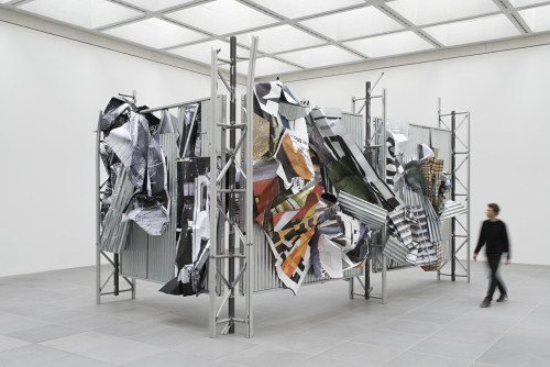 
     <i>dermaßen regiert zu werden</i>, 
     2015 (front)<br />
     aluminium, stainless steel, digital print, 
      450 x 765 x 415 cm<br />
     Exhibition view, Neues Museum, Nuremberg, Germany, 2015