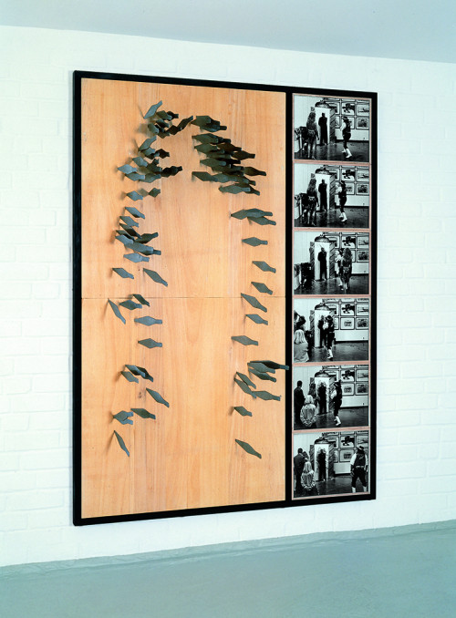 
     <i>Timm Ulrichs Messerwurf-Porträt</i>, 
     1978/1991<br />
     90 stainless steel throwing knifes, wooden tablet, 
      200 x 100 cm<br />
     A performance for Timm Ulrichs exhibition opening at Kunsthalle Recklinghausen in 1991. The knife were thrown by Jonny King.